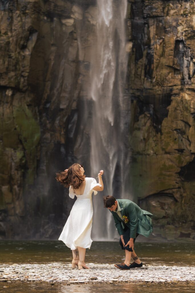 A newlywed couple that had just eloped dancing at the base of Letchworth State Park waterfall