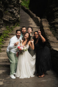 A bride and groom eloping in Watkins Glen State Park with their friends in a micro-wedding setting