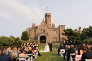 wedding ceremony in front of a castle venue