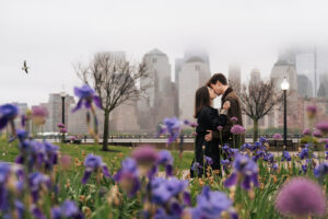 a couple kiss on a rainy day overlooking new york skyline