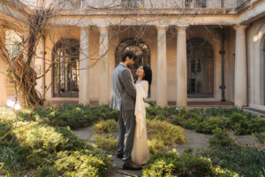 a couple embraced among a garden 