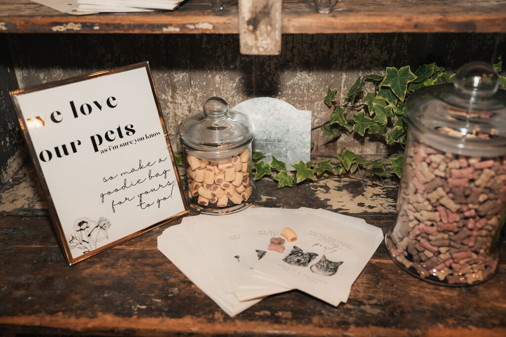 a display of wedding favors that include to go bags of cat and dog treats