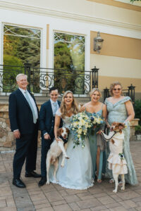 a family posing with their two dogs