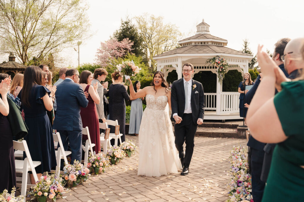 bride and groom walking down the aisle at The Conservatory wedding venue in New Jersey