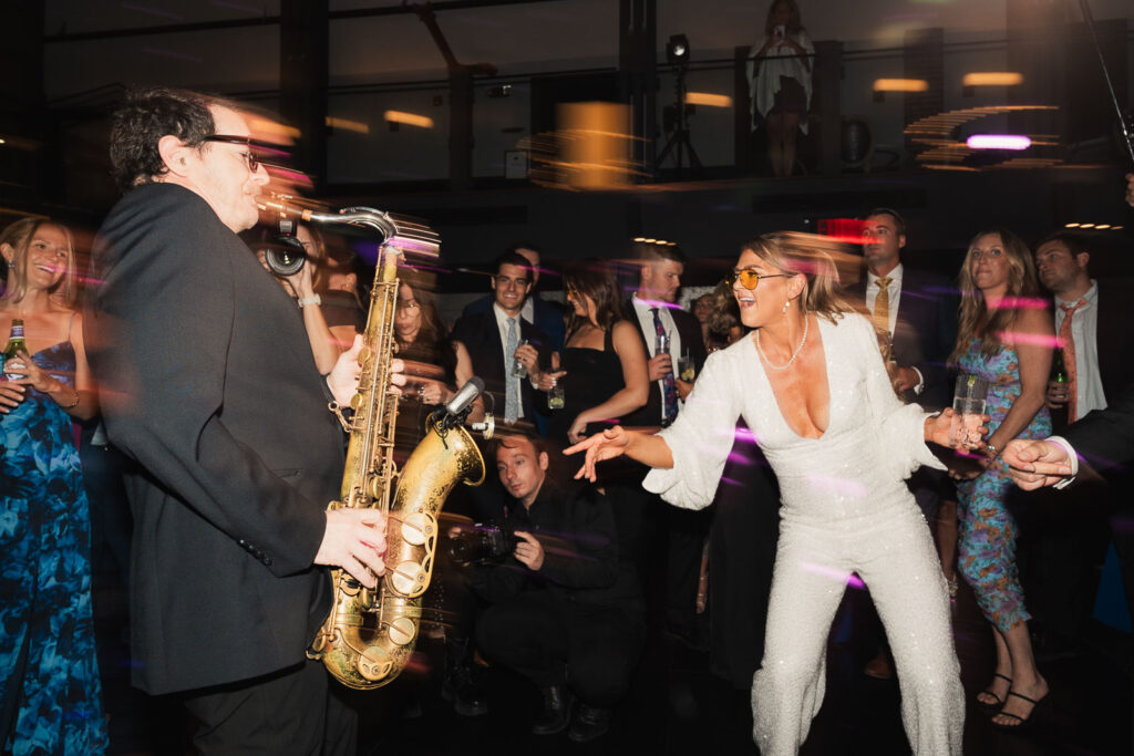 bride dancing to the sax player