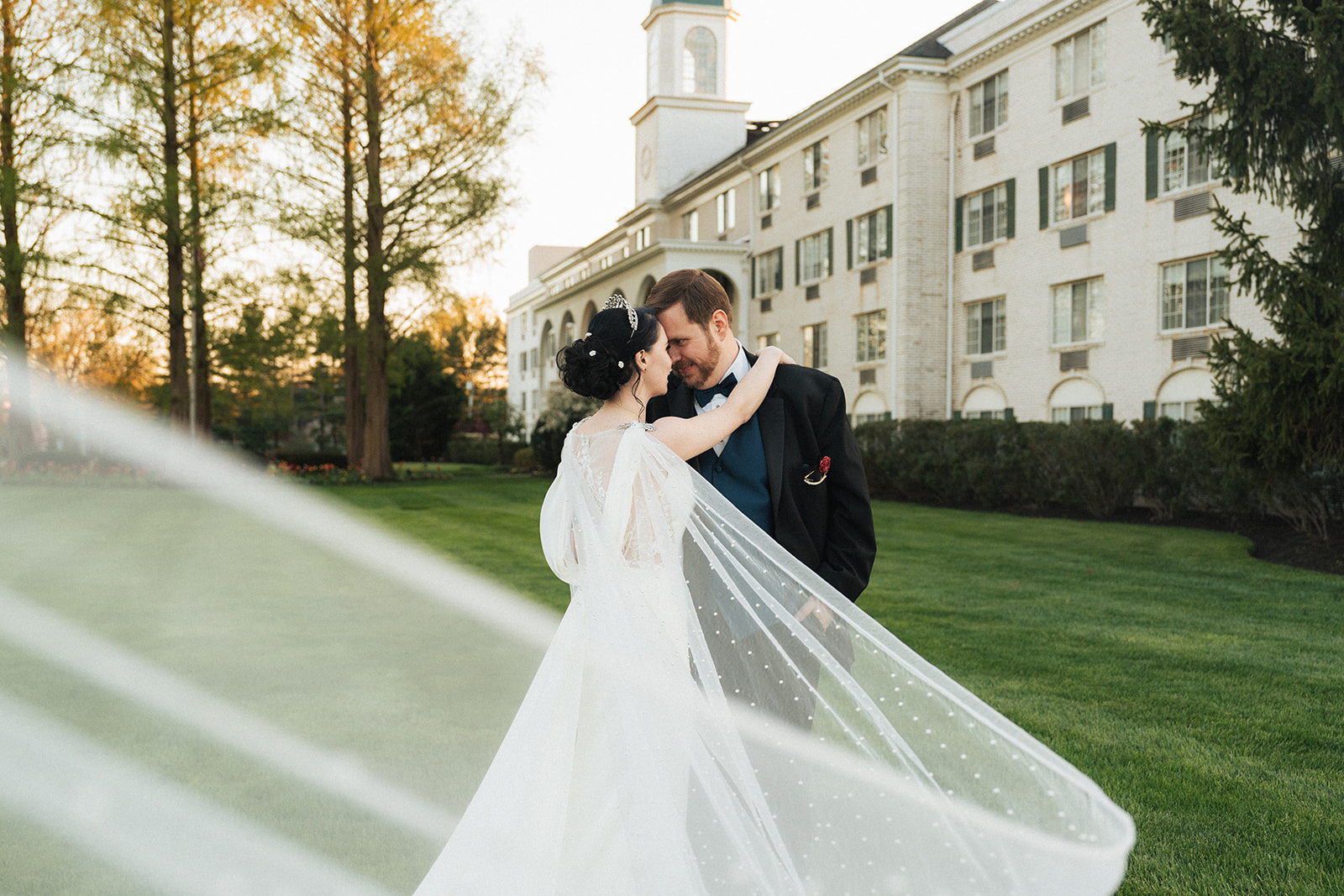 a bride and groom with a long veil