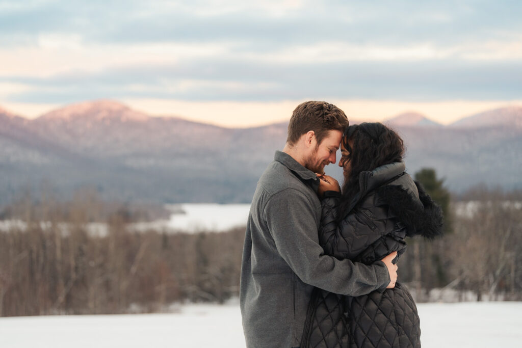 a couple during a winter sunset and mountains in the background