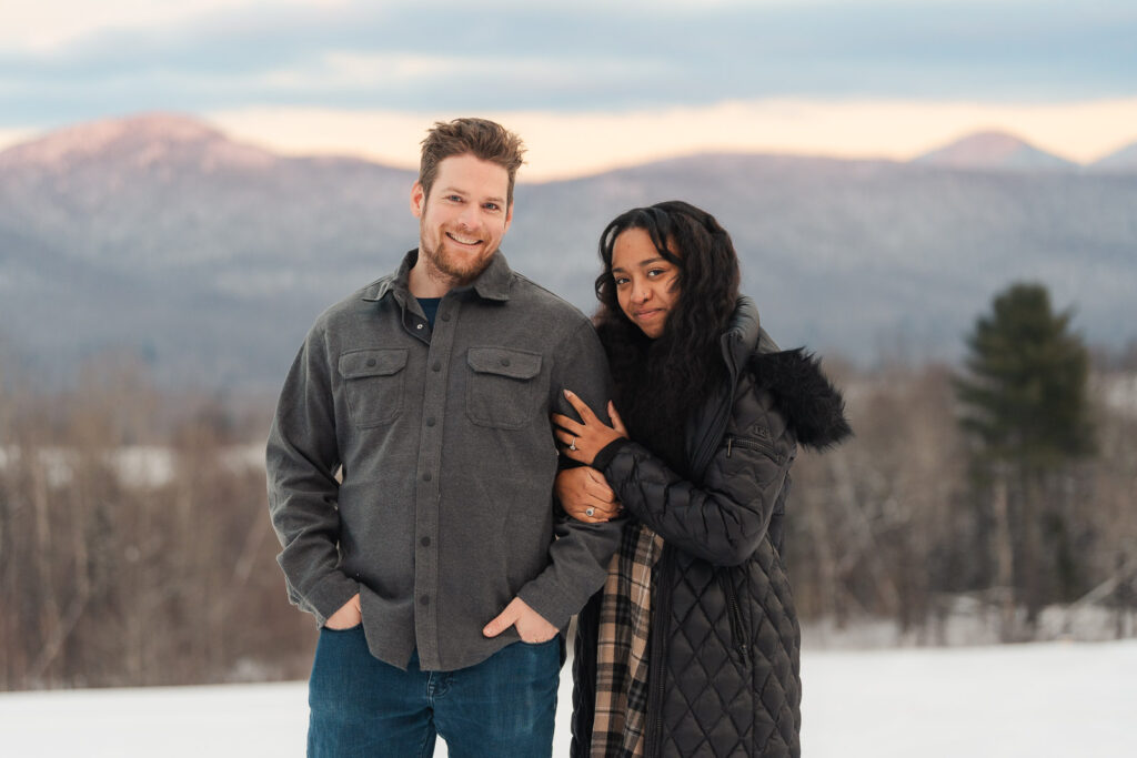 a couple during a winter sunset and mountains in the background