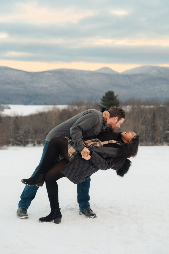 a couple during a winter sunset and mountains in the background