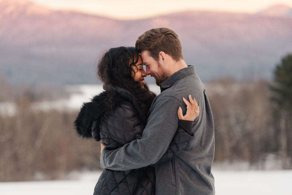 a couple during a winter sunset and mountains in the background