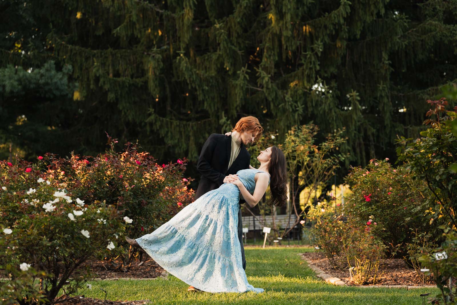 a couple taking anniversary photos in a park during summer