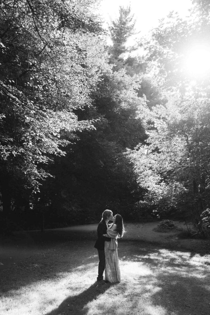 a couple taking anniversary photos in a park during summer