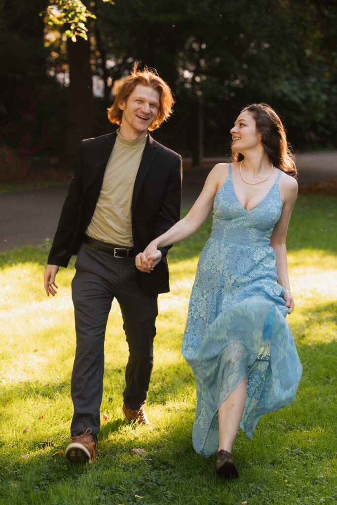 a couple taking anniversary photos in a park during summer