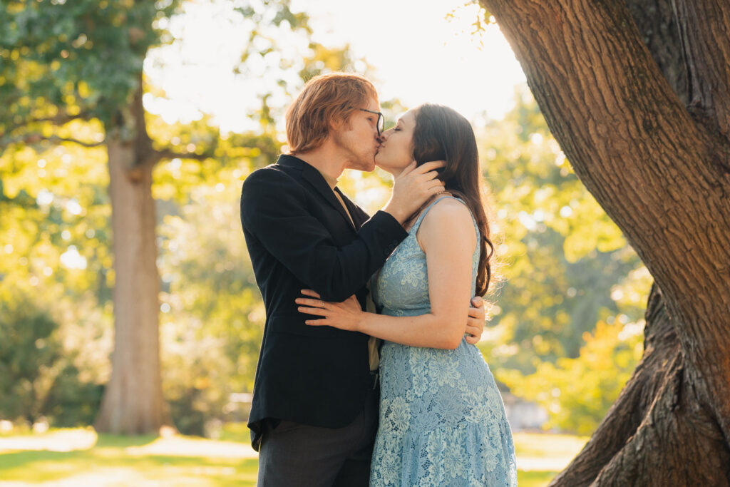 a couple taking anniversary photos in a park during summer