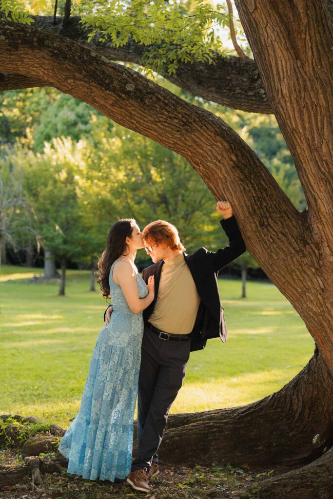 a couple taking anniversary photos in a park during summer