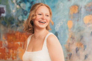 a bride on her wedding day with colorful painting in the background