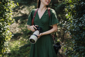 a female photographer outside in greenery