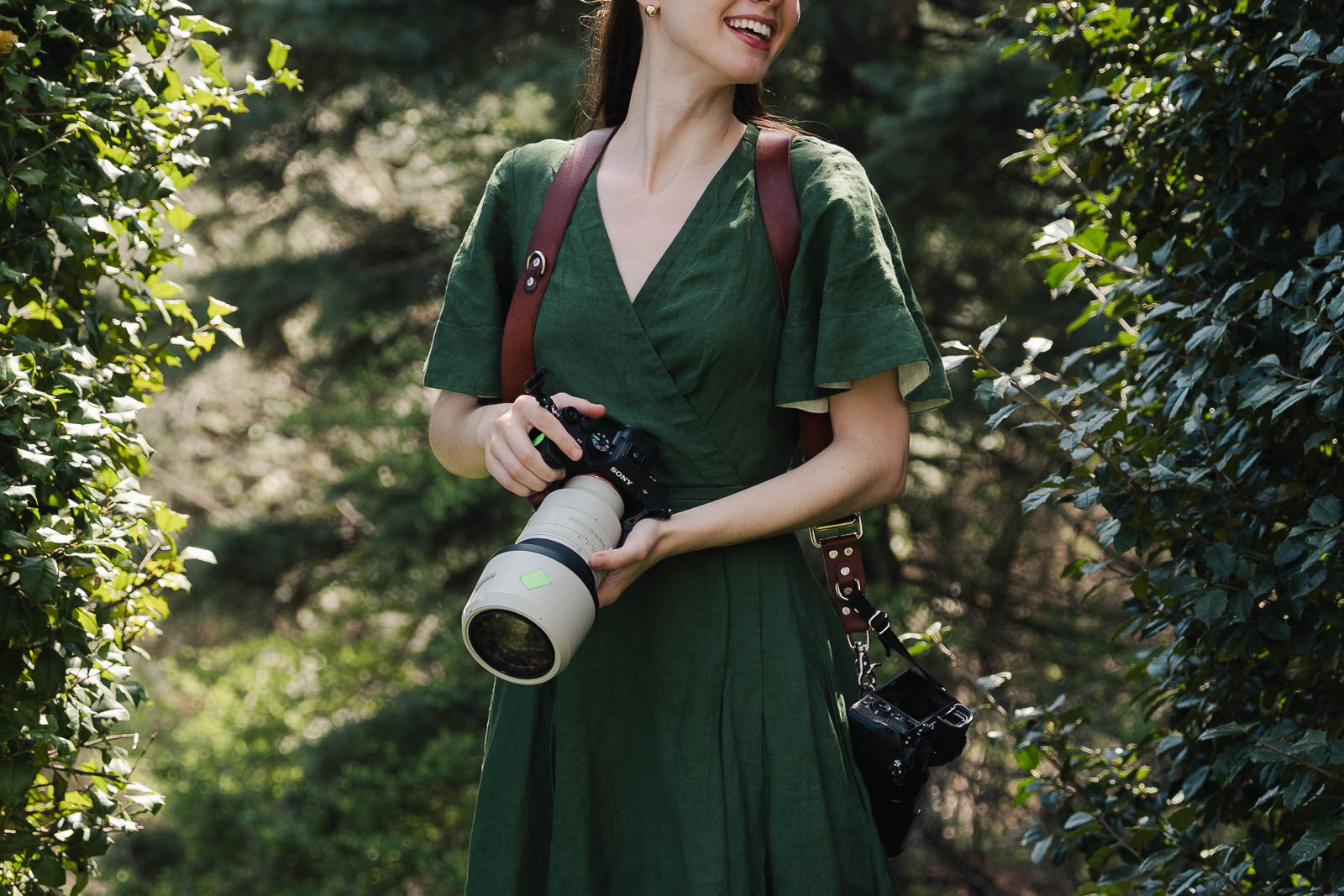a female photographer outside in greenery