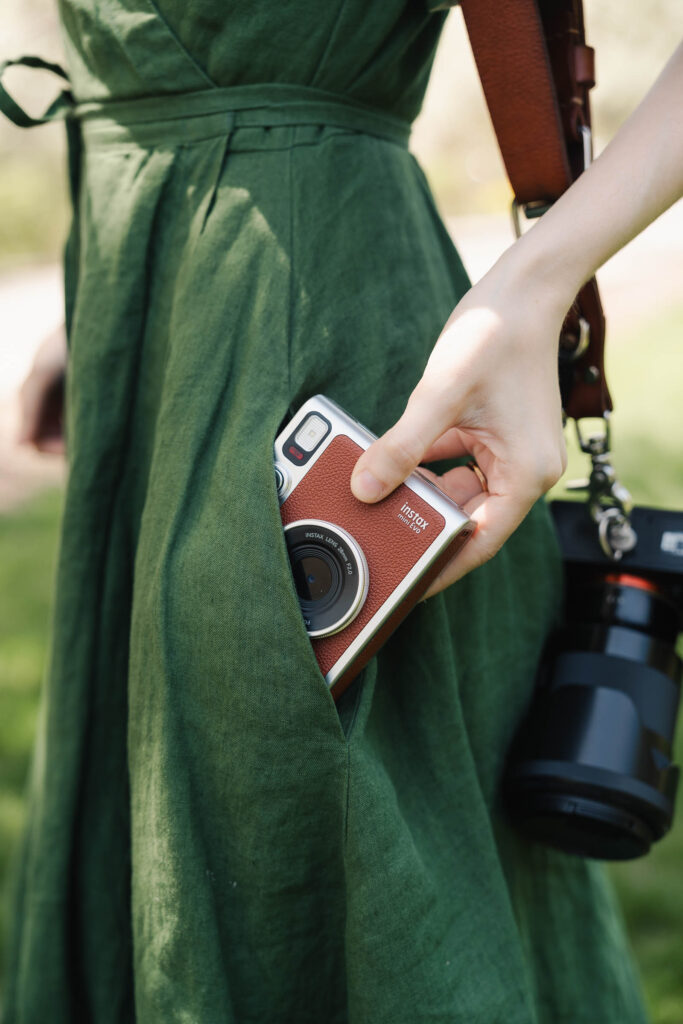 a woman photographer wearing a green linen wrap dress