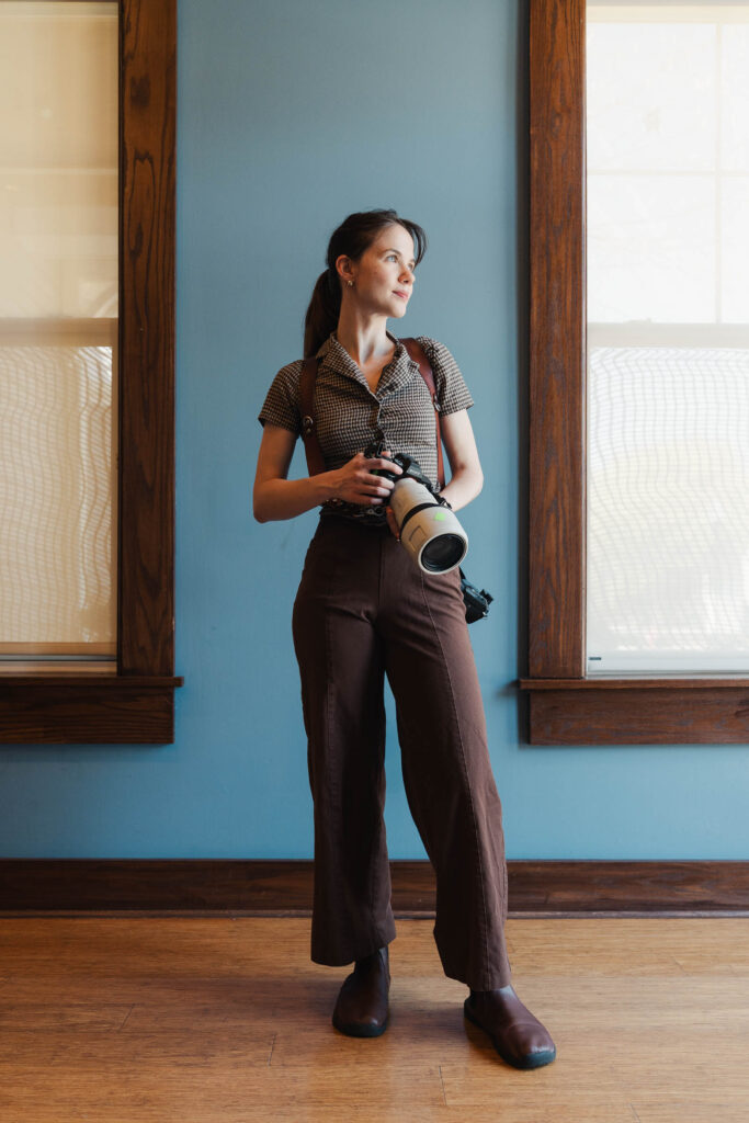 a female photographer in brown work outfit