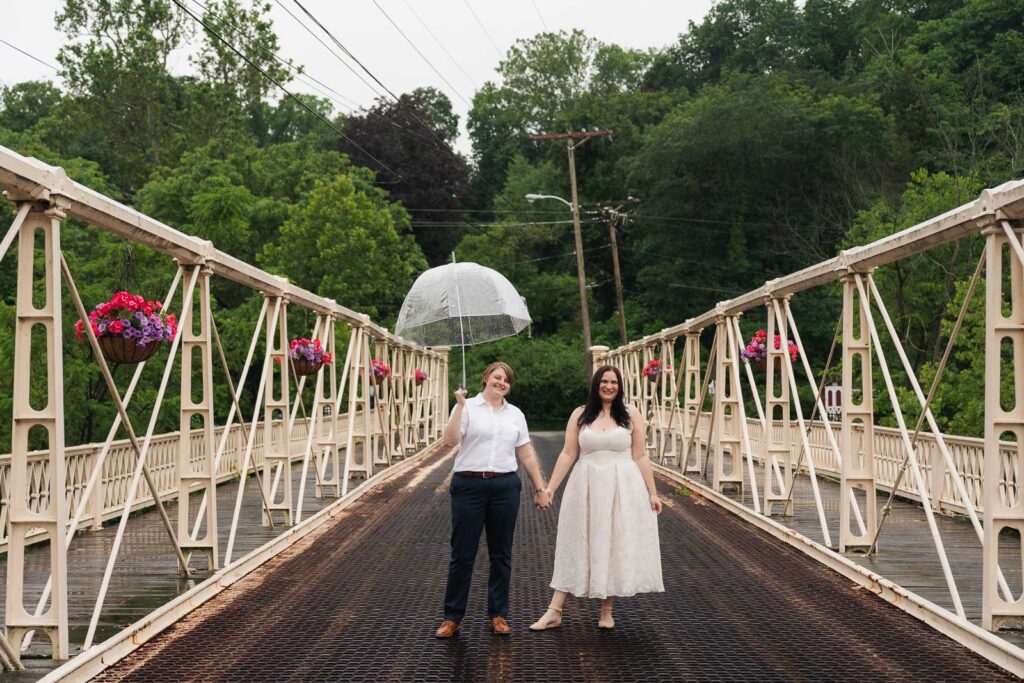 Romantic rainy day engagement photo with glowing street lamps in downtown Clinton