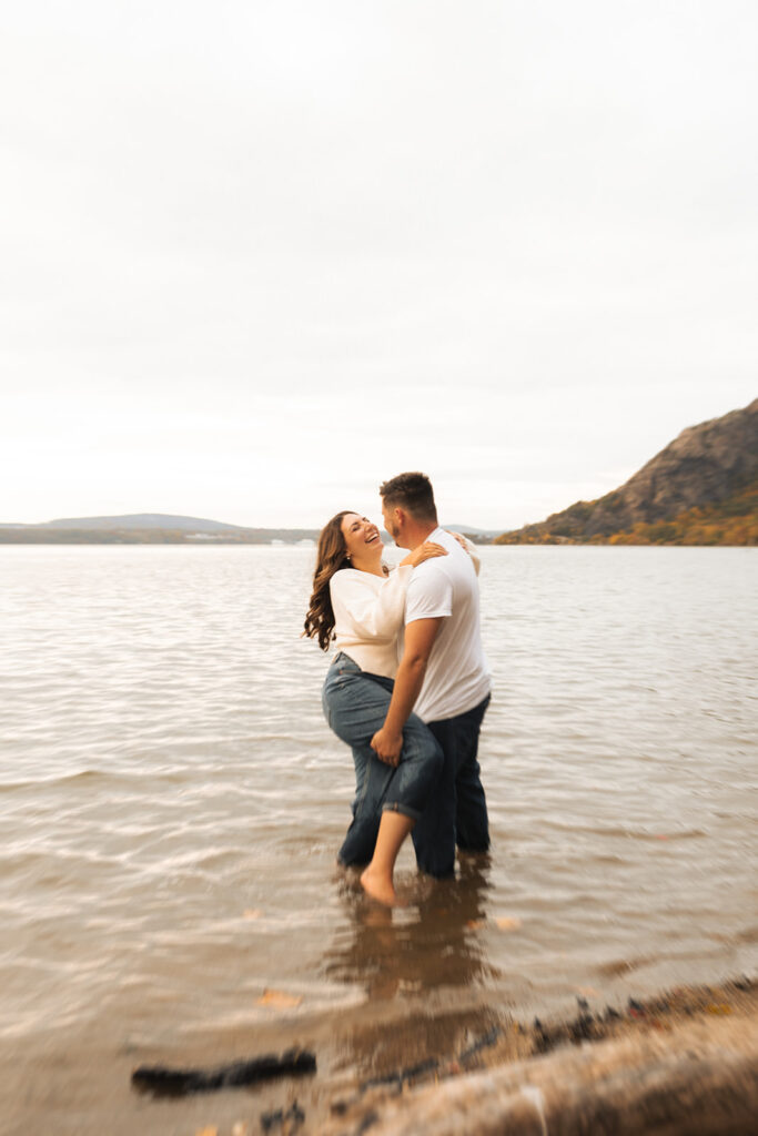 Couple hiking around cold springs new york for engagement photos in autumn