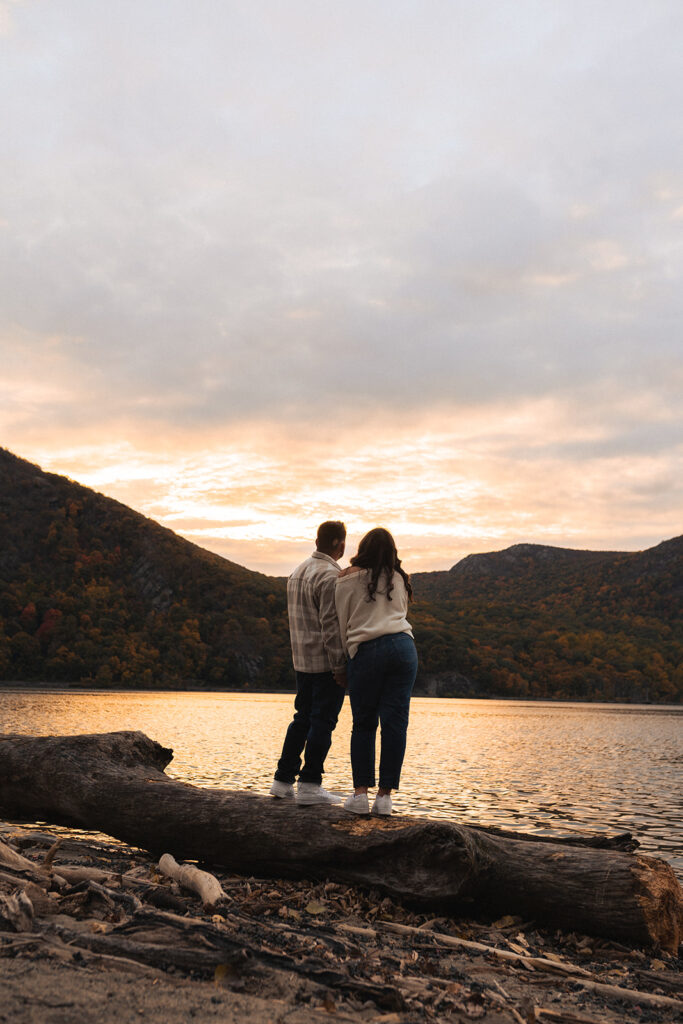 Couple hiking around cold springs new york for engagement photos in autumn