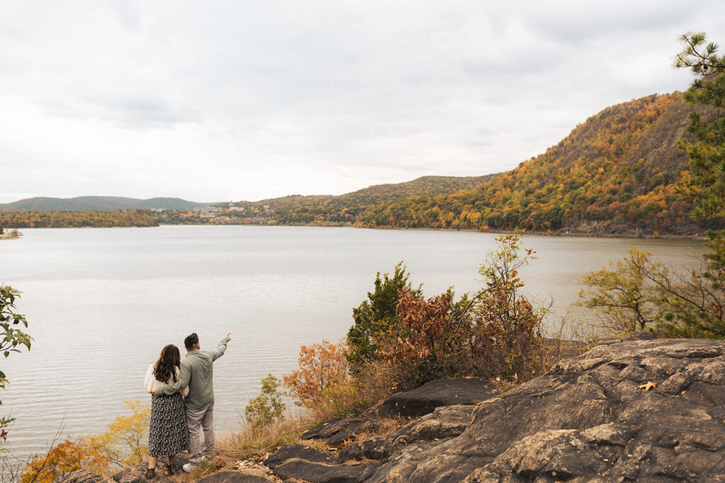 Couple hiking around cold springs new york for engagement photos in autumn