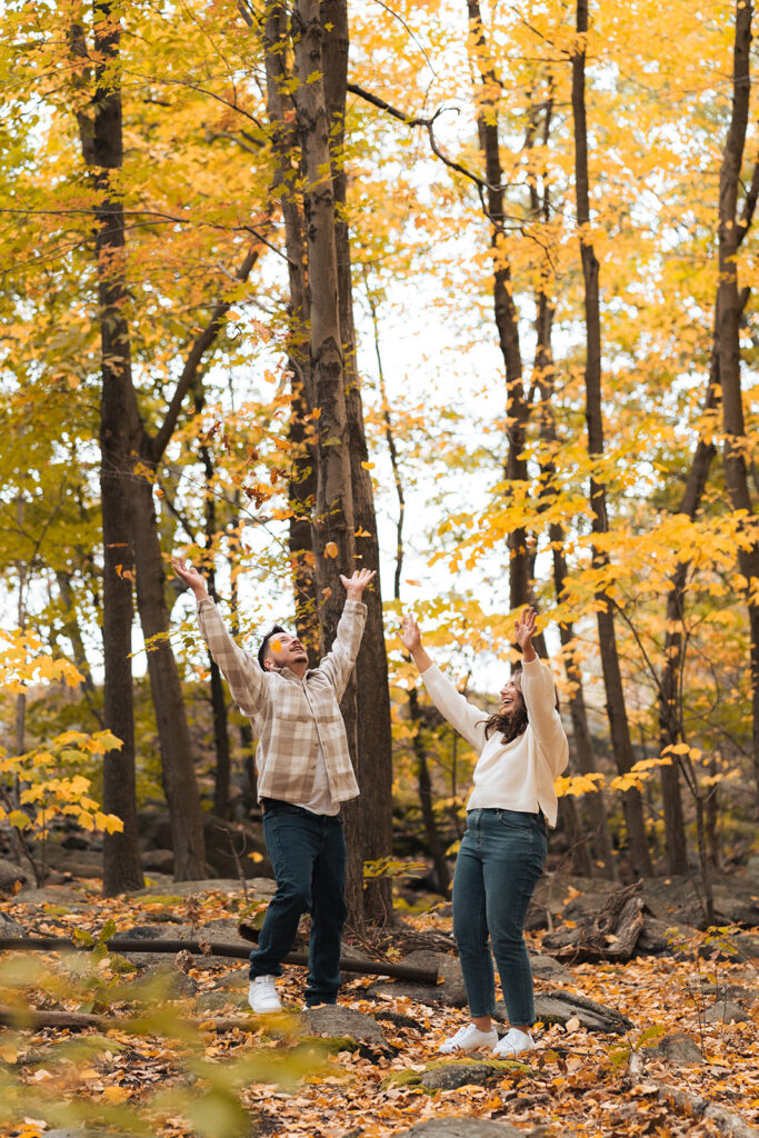 Couple hiking around cold springs new york for engagement photos in autumn