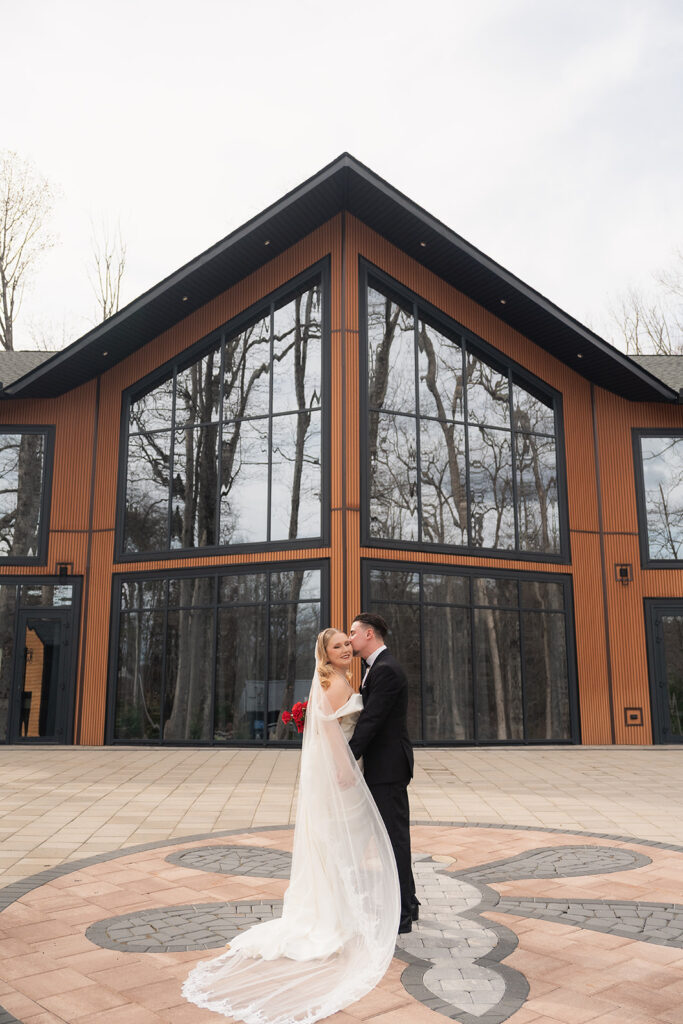Bride and groom outside the main lodge of Leisure Lake in The Poconos.