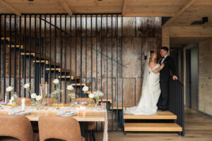 Newlyweds embrace each other inside a decorated interior for a micro wedding at Leisure Lake in The Poconos.