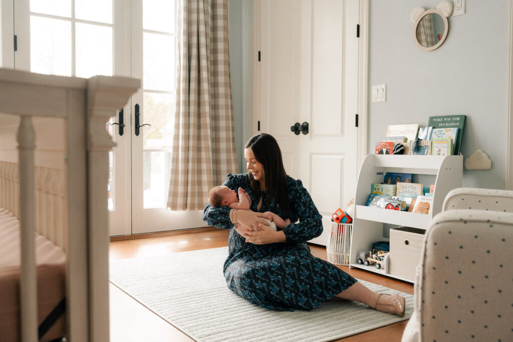 A mom and father hold their newborn for an intimate newborn photography session.