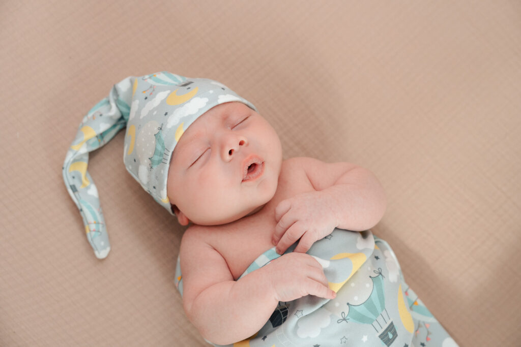 A mom and father hold their newborn for an intimate newborn photography session.