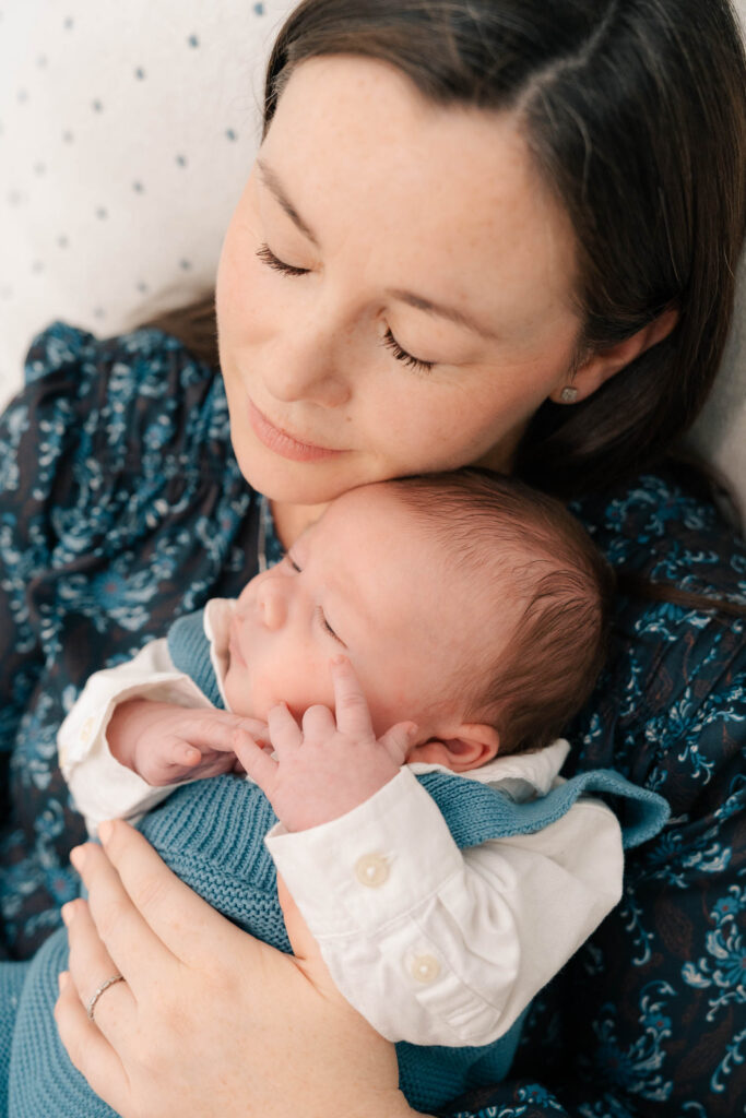 A mom and father hold their newborn for an intimate newborn photography session.