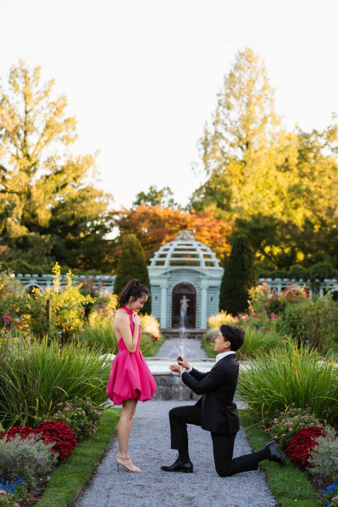 A romantic autumn proposal at Old Westbury Gardens in Old Westbury, New York, featuring a surprise family reveal, golden hour portraits, and a joyful engagement celebration
