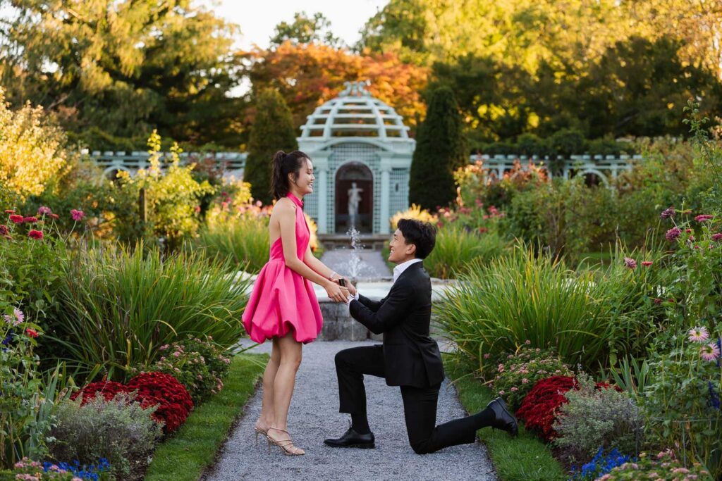 A romantic autumn proposal at Old Westbury Gardens in Old Westbury, New York, featuring a surprise family reveal, golden hour portraits, and a joyful engagement celebration