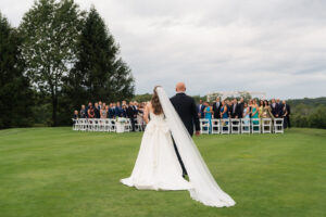 A bride and her father walk down the aisle at Skyview Gold Club. 