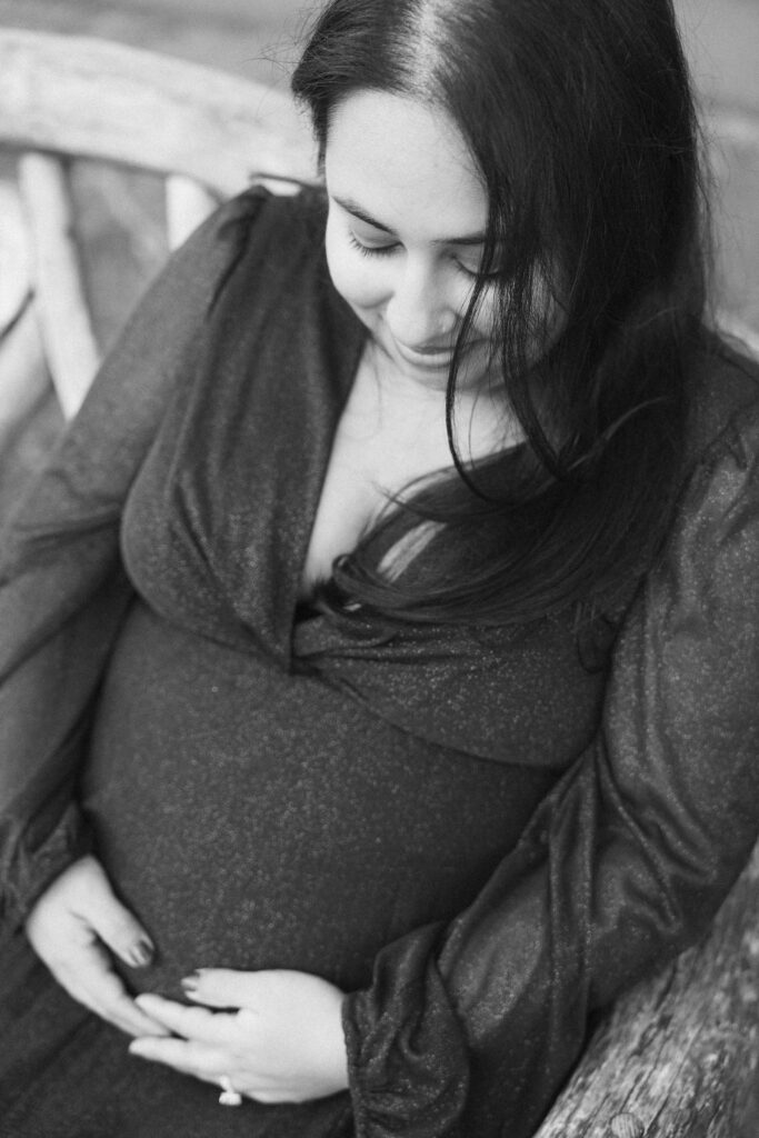 A winter maternity session at Bear Mountain State Park near Bear Mountain Inn, featuring golden hour light, a red dress, and a couple expecting their baby boy.
