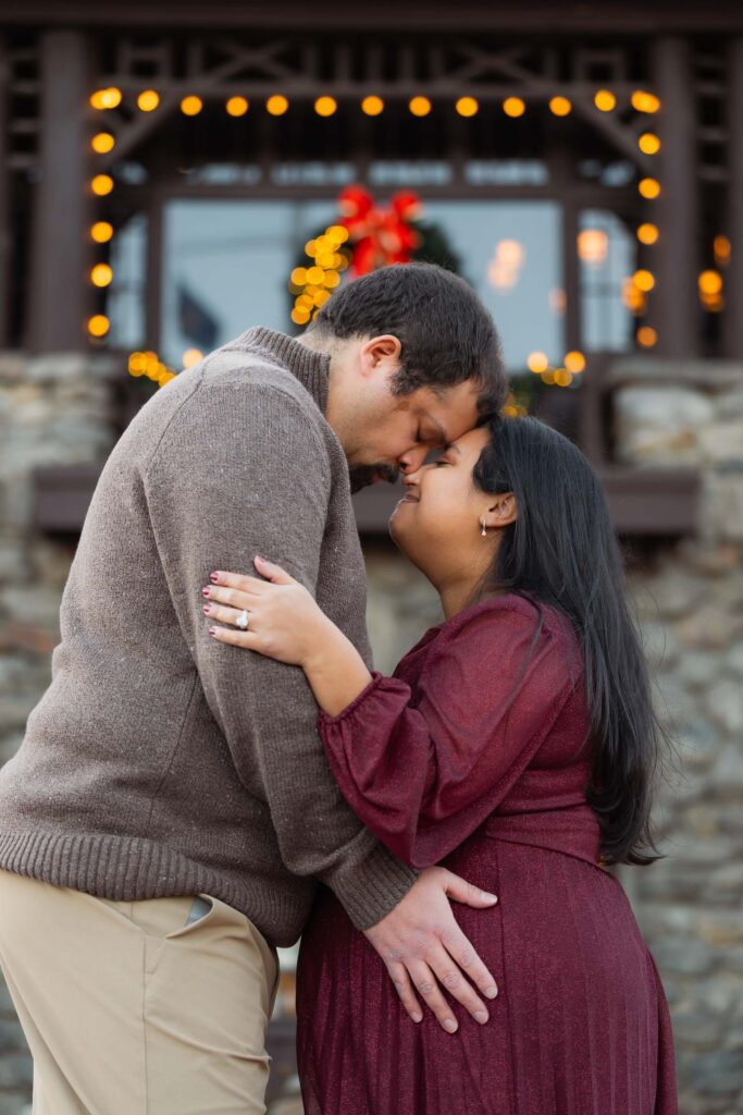 A winter maternity session at Bear Mountain State Park near Bear Mountain Inn, featuring golden hour light, a red dress, and a couple expecting their baby boy.