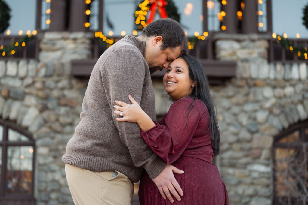A winter maternity session at Bear Mountain State Park near Bear Mountain Inn, featuring golden hour light, a red dress, and a couple expecting their baby boy.