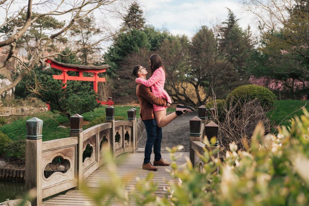 A proposal during cherry blossom season at Brooklyn Botanic Gardens.