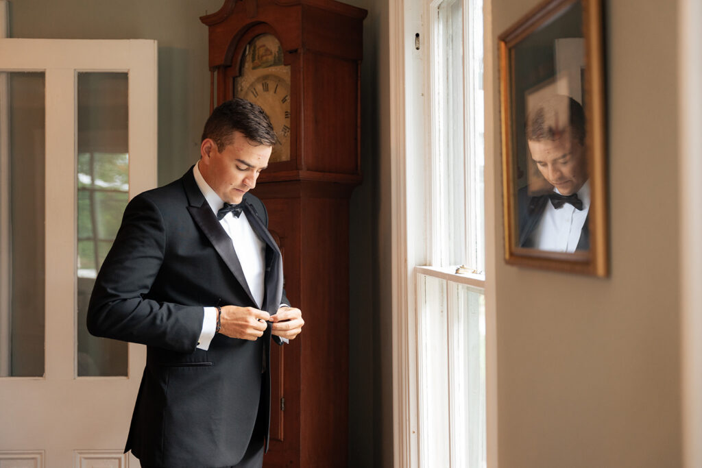 A groom getting ready in a rustic mansion in a New Jersey wedding venue.