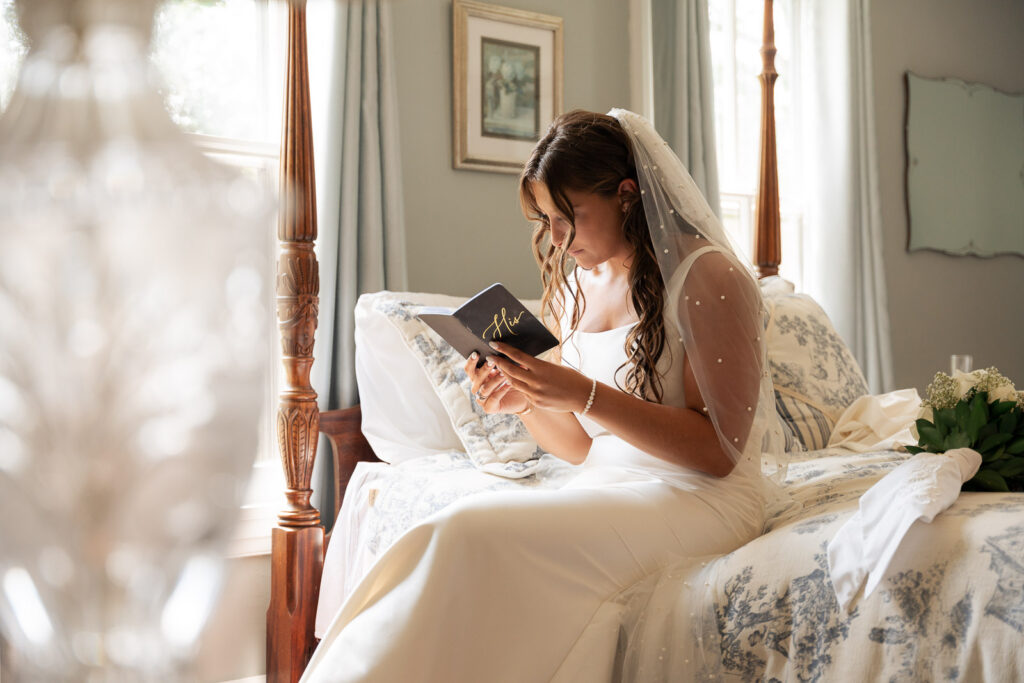 A bride reading a letter from her groom on her wedding day in New Jersey.