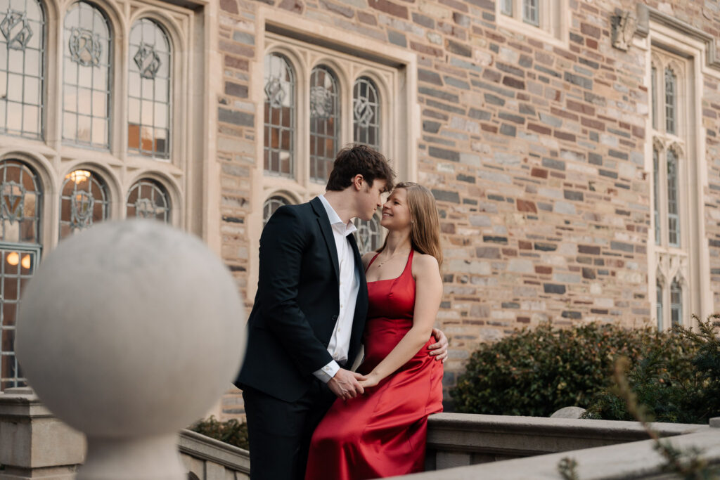A snowy late winter engagement session at Princeton University in Princeton, NJ, featuring golden hour portraits, a red ballgown, classic architecture, and romantic nighttime photos.
