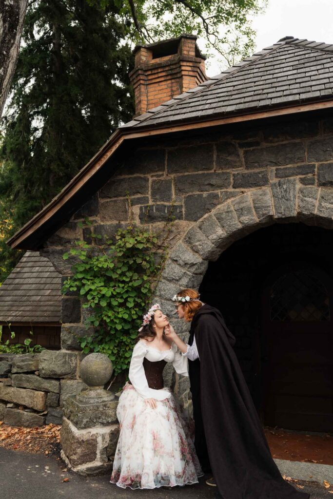 A Renaissance-inspired autumn engagement session at Skylands Manor and the New Jersey Botanical Gardens in Ringwood, NJ, featuring flower crowns, a wool cape, and romantic garden portraits before a Stone House wedding.