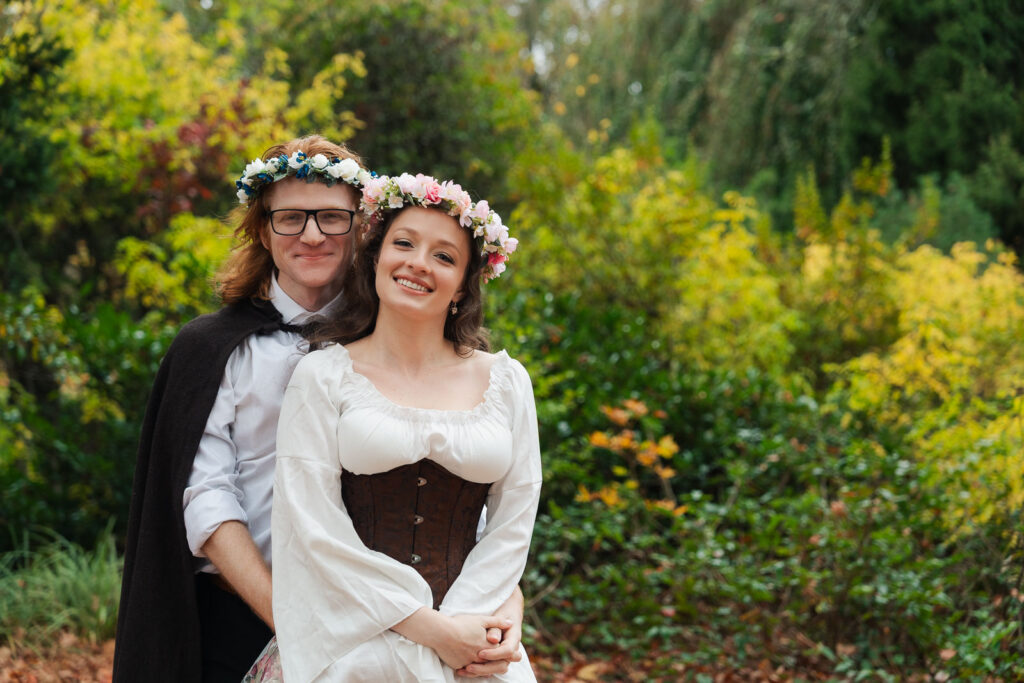 A Renaissance-inspired autumn engagement session at Skylands Manor and the New Jersey Botanical Gardens in Ringwood, NJ, featuring flower crowns, a wool cape, and romantic garden portraits before a Stone House wedding.