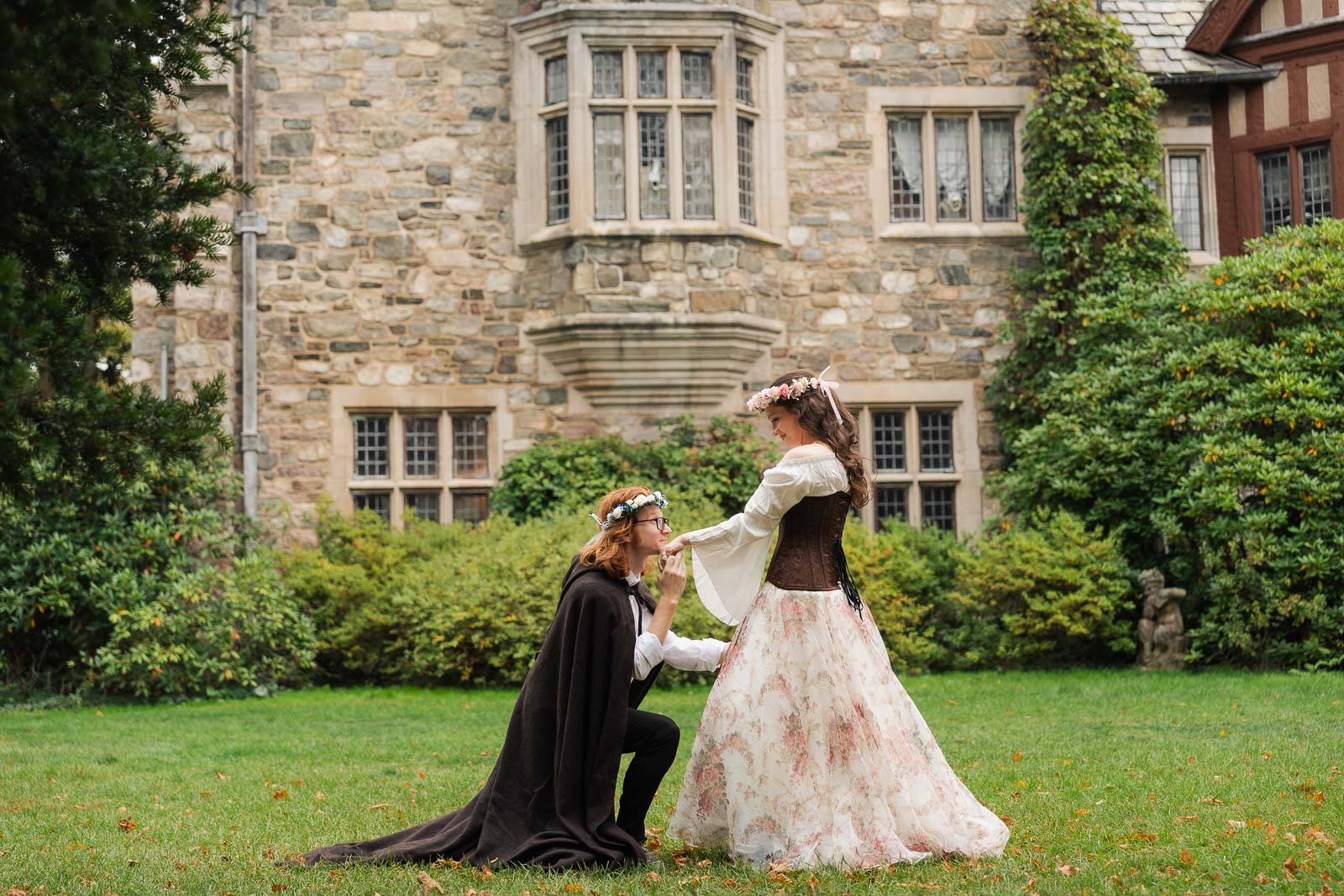 A Renaissance-inspired autumn engagement session at Skylands Manor and the New Jersey Botanical Gardens in Ringwood, NJ, featuring flower crowns, a wool cape, and romantic garden portraits before a Stone House wedding.