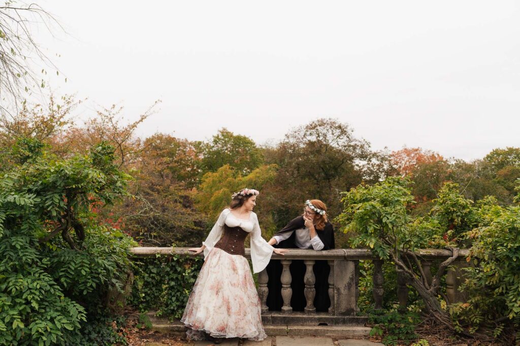 A Renaissance-inspired autumn engagement session at Skylands Manor and the New Jersey Botanical Gardens in Ringwood, NJ, featuring flower crowns, a wool cape, and romantic garden portraits before a Stone House wedding.