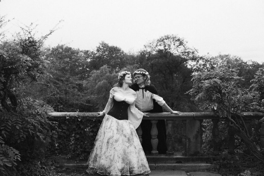 A Renaissance-inspired autumn engagement session at Skylands Manor and the New Jersey Botanical Gardens in Ringwood, NJ, featuring flower crowns, a wool cape, and romantic garden portraits before a Stone House wedding.