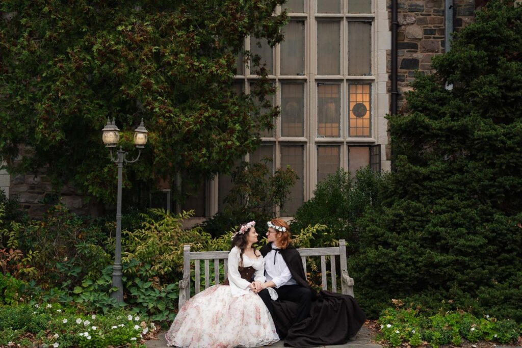 A Renaissance-inspired autumn engagement session at Skylands Manor and the New Jersey Botanical Gardens in Ringwood, NJ, featuring flower crowns, a wool cape, and romantic garden portraits before a Stone House wedding.